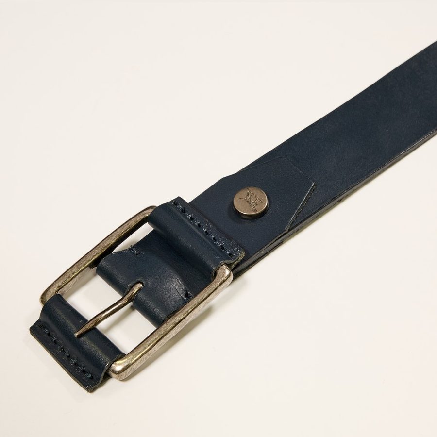 Detail of a blue belt with buckle and visible stitching
